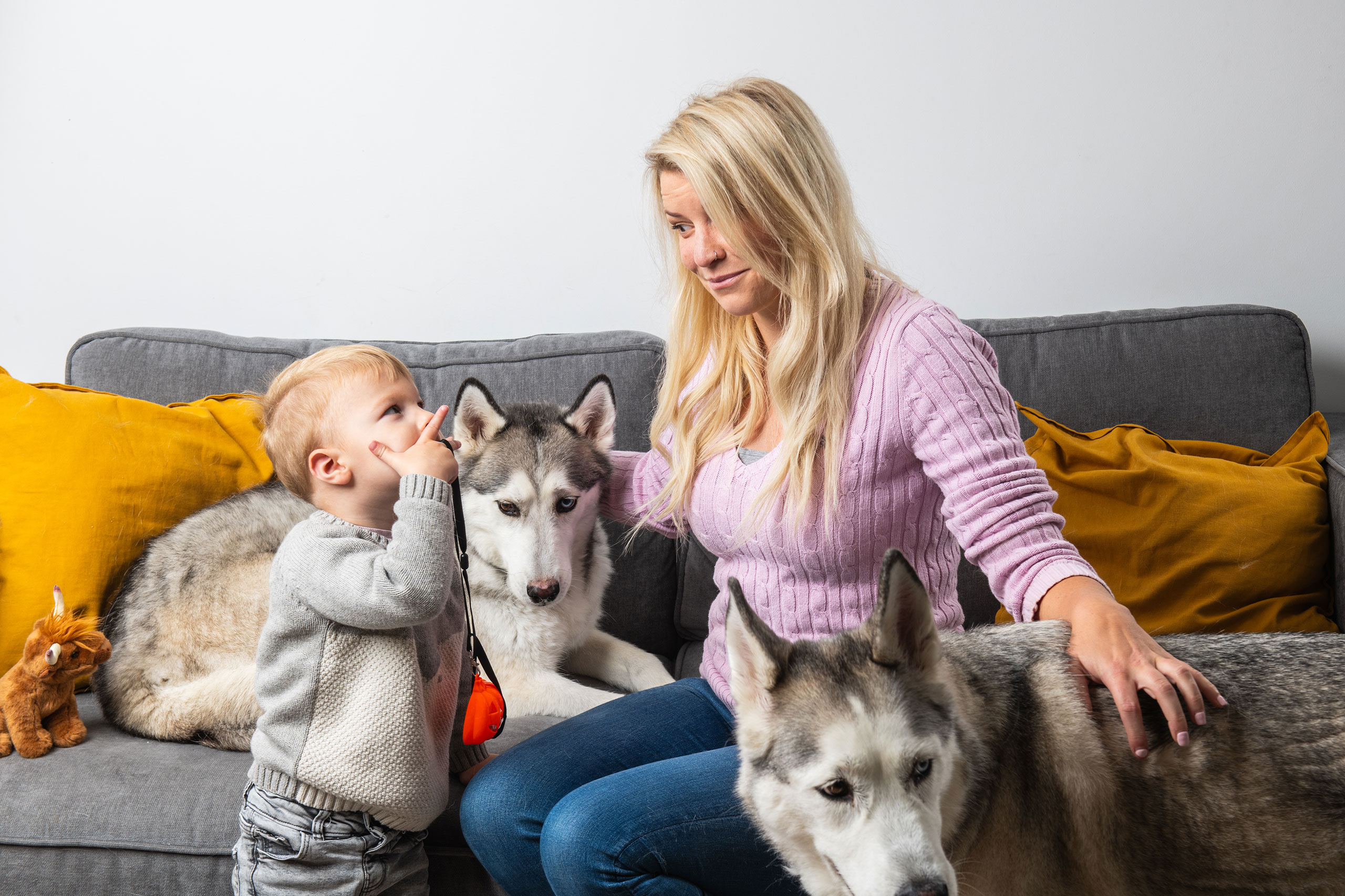 Sparrow customer smiling at child with two dogs