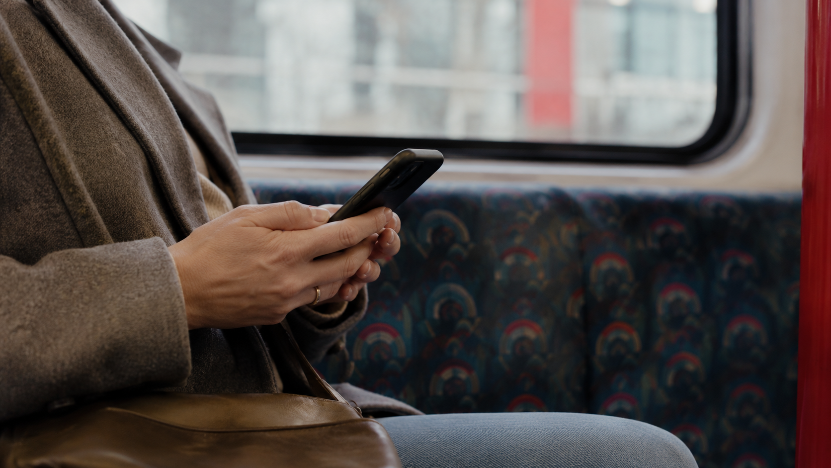 Person on the tube looking at their phone
